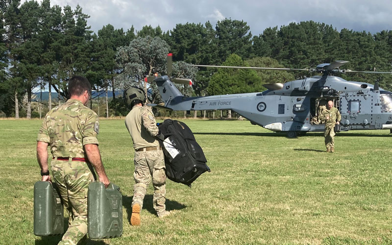 Soldiers moving supplies to an NH90